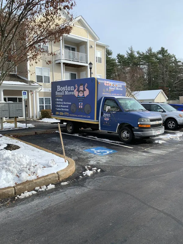 Boston Small Moves truck outside apartments with snow on the ground