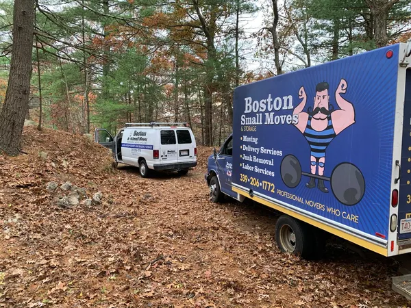 Boston Small Moves truck and van on a wooded driveway in autumn